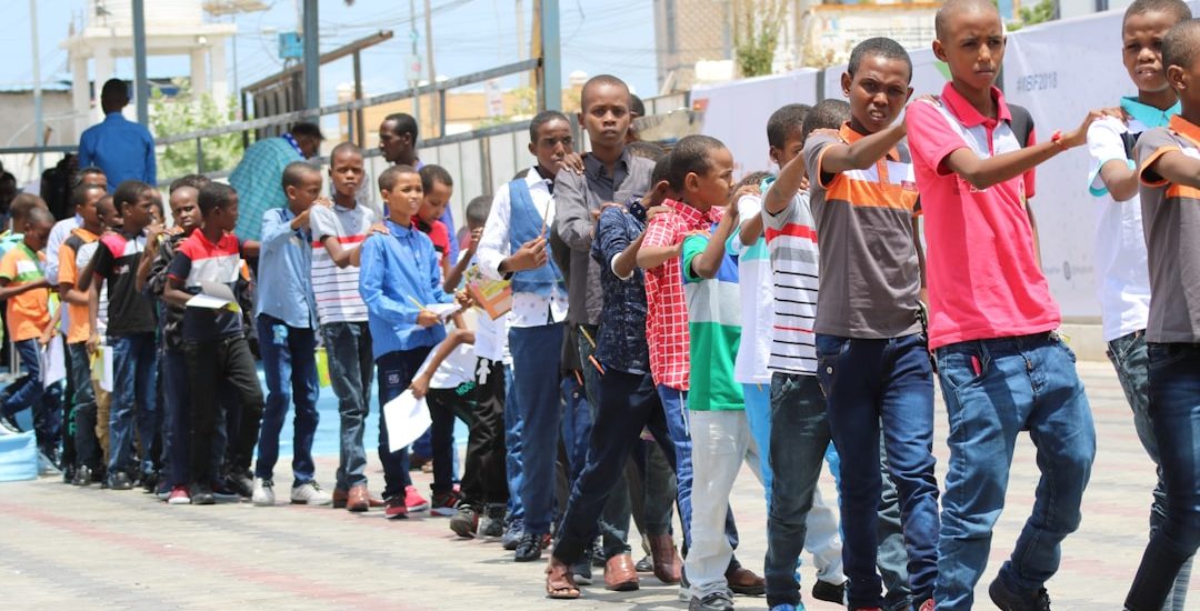 group of people standing on street during daytime