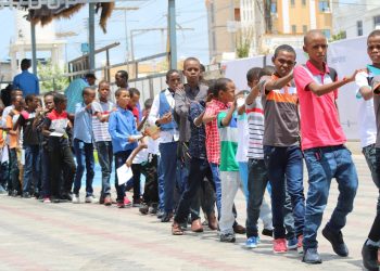 group of people standing on street during daytime
